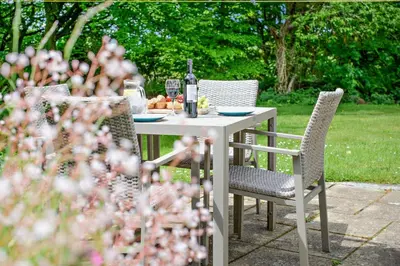a table with a bottle of wine and fruit on it at 2 Bed in Advent oc-s6025 in Camelford