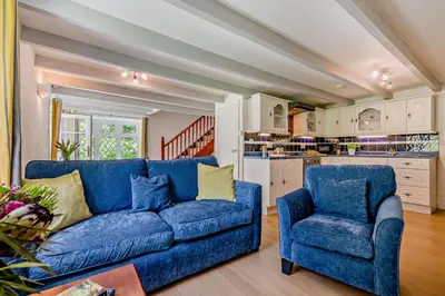 a living room with a blue couch and two chairs at 2 Bed in Advent oc-s6025 in Camelford
