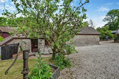 a house with a hose in front of a tree at 1 Bed in Advent oc-b29387 in Camelford