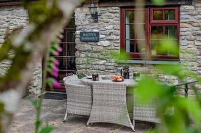 a table and chairs in front of a building at 1 Bed in Advent oc-b29387 in Camelford