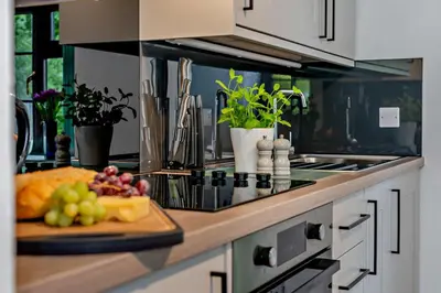 a kitchen counter with a plate of fruit on a cutting board at 1 Bed in Advent oc-b29387 in Camelford