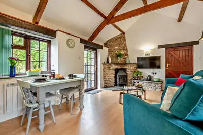 a kitchen and living room with a table and a couch at 1 Bed in Advent oc-b29387 in Camelford