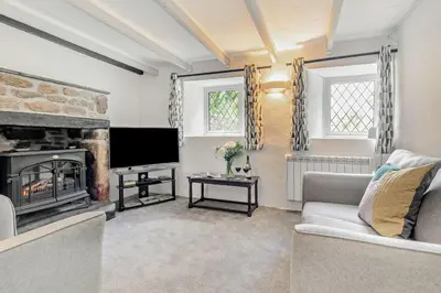 a living room with a fireplace and a television at 2 Bed in Advent oc-p6188 in Camelford