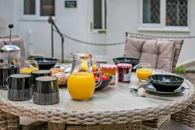 a table with orange juice and food on it at 2 Bed in Advent oc-p6188 in Camelford