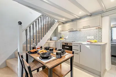 a kitchen with white cabinets and a table with food on it at 2 Bed in Advent oc-p6188 in Camelford