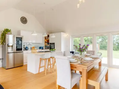 a kitchen and dining room with a table and chairs at 3 Bed in Saltash oc-88525 in Landrake