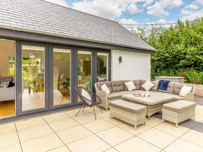 a conservatory with a couch and a table on a patio at 3 Bed in Saltash oc-88525 in Landrake
