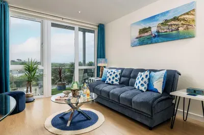 a living room with a couch and a table at 32 Tre Lowen in Newquay