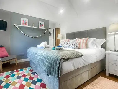 a bedroom with a large bed in a room at Penty Lowen in Saint Mawes