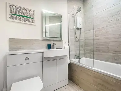 a bathroom with a toilet and a sink and a shower at Penty Lowen in Saint Mawes