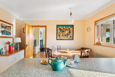 a kitchen with a table with a teapot on a counter at Peaceful cottage with views - Fairview Cottage in Mylor Bridge