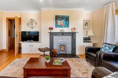 a living room with a couch and a fireplace at Peaceful cottage with views - Fairview Cottage in Mylor Bridge