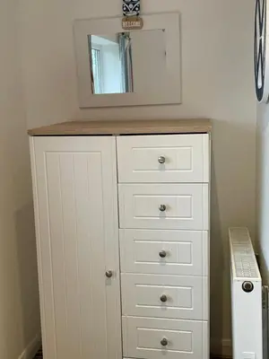 a white dresser with a mirror on top of it at Atlantic Reach – Cozy 2-Bed with Parking in Newquay