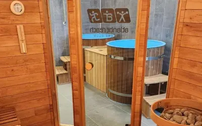 a room with two wine barrels and a clock on the wall at Atlantic Reach – Cozy 2-Bed with Parking in Newquay