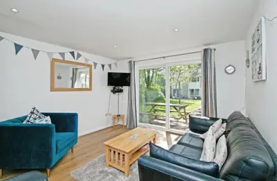 a living room with a couch and a table at Atlantic Reach – Cozy 2-Bed with Parking in Newquay