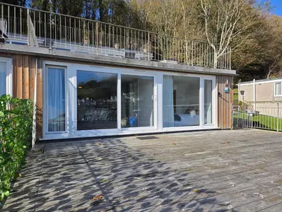 a house with large glass doors on a deck at Millendreath Oean View Villa in Saint Martin