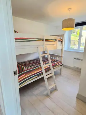 a room with two bunk beds and a ladder at Millendreath Oean View Villa in Saint Martin