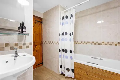 a bathroom with a sink and a tub and a shower at Myrtle Grove in Saint Endellion