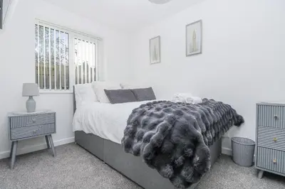 a bedroom with a bed with a blanket on it at Cosy Retreat in Camborne