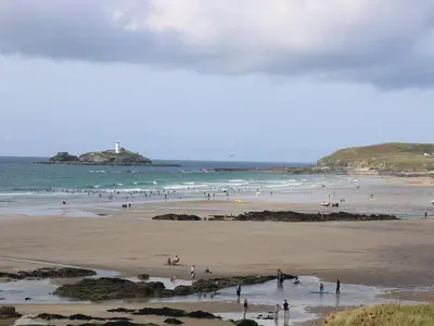 a group of people on a beach near the ocean at Cosy Retreat in Camborne