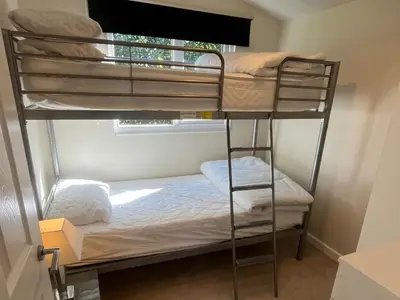 a room with two bunk beds and a window at Stanbury in Padstow
