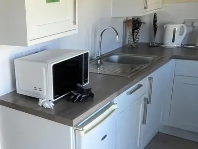 a microwave sitting on a counter in a kitchen at Stanbury in Padstow