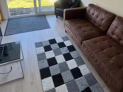 a living room with a couch and a checkered floor at Stanbury in Padstow
