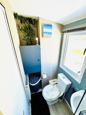 a small bathroom with a toilet and a window at Holiday Home with Hot Tub Cornish Country SeaSide in Porth