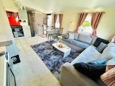 a living room with a couch and a table at Holiday Home with Hot Tub Cornish Country SeaSide in Porth