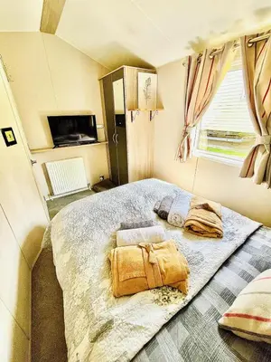 a bedroom with a large bed in a room at Holiday Home with Hot Tub Cornish Country SeaSide in Porth