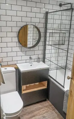 a bathroom with a sink and a mirror at Mor Ki -A perfectly situated modern flat in Looe in Looe
