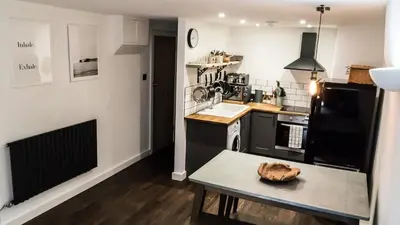 a kitchen with a table with a bowl on it at Mor Ki -A perfectly situated modern flat in Looe in Looe