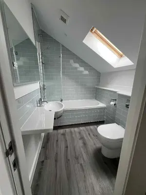 a bathroom with a white toilet and a sink at Wave Side Lodge 106B- Retallack Resort & Spa in Saint Columb Major