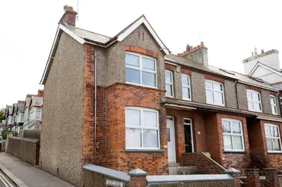 an old brick house on the side of a street at Stone's Throw // Central Newquay // Parking in Newquay