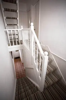 a staircase with white railings in a house at Stone's Throw // Central Newquay // Parking in Newquay