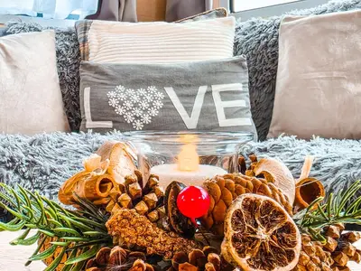 a candle sitting on a couch with a pile of nuts at Ocean Breeze in Truro
