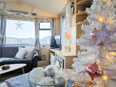 a living room with a christmas tree and a couch at Ocean Breeze in Truro
