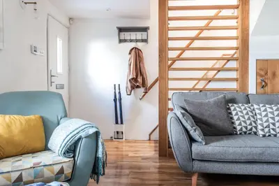 a living room with a couch and a chair at Wavecrest in Portreath