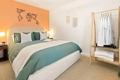 a bedroom with a large bed in a room at Ye Old Mill - Stylish cosy retreat with parking in Penryn