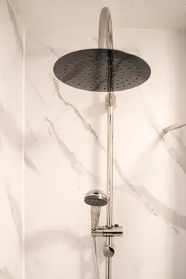 a shower head on a pole in a bathroom at Ye Old Mill - Stylish cosy retreat with parking in Penryn