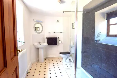 a bathroom with a toilet and a sink and a shower at Finest Retreats - Fields Barn in Widemouth Bay