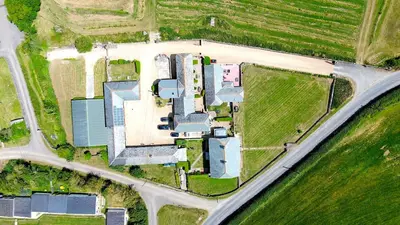 an aerial view of a building in a field at Finest Retreats - Olive Tree in Widemouth Bay