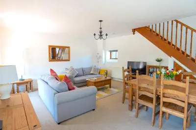 a living room with a couch and a table at Finest Retreats - Olive Tree in Widemouth Bay