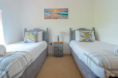 two beds sitting next to each other in a bedroom at Finest Retreats - Olive Tree in Widemouth Bay