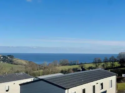 a view of a house with solar panels on the roof at Polperro Seaview Lodge in Polperro