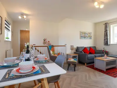 a living room with a table and a couch at Yonja Homes in St Austell