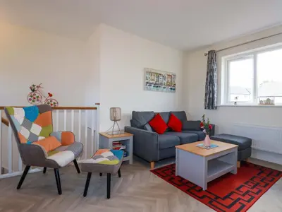 a living room with a couch and a table at Yonja Homes in St Austell