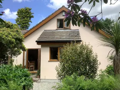a small white house with a roof at Poldurn in St Austell