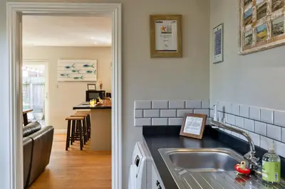 a kitchen with a sink and a counter at Finest Retreats - Gwelmor in Widemouth Bay