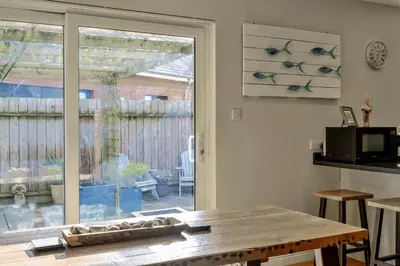 a kitchen with a table and a sliding glass door at Finest Retreats - Gwelmor in Widemouth Bay